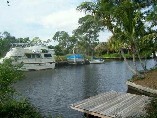 1904 Northwest Pine Tree Way Stuart, FL 34994 - Photo 6 of 8 a view of a lake with houses