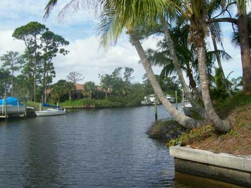 1904 Northwest Pine Tree Way Stuart, FL 34994 - Photo 7 of 8 a view of a lake with houses