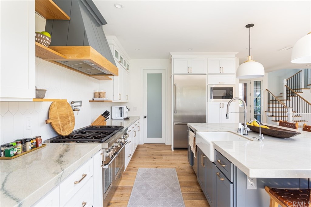 477 Magnolia Street Costa Mesa, CA 92627 - Photo 13 of 29 a kitchen with kitchen island granite countertop a sink a counter and stove