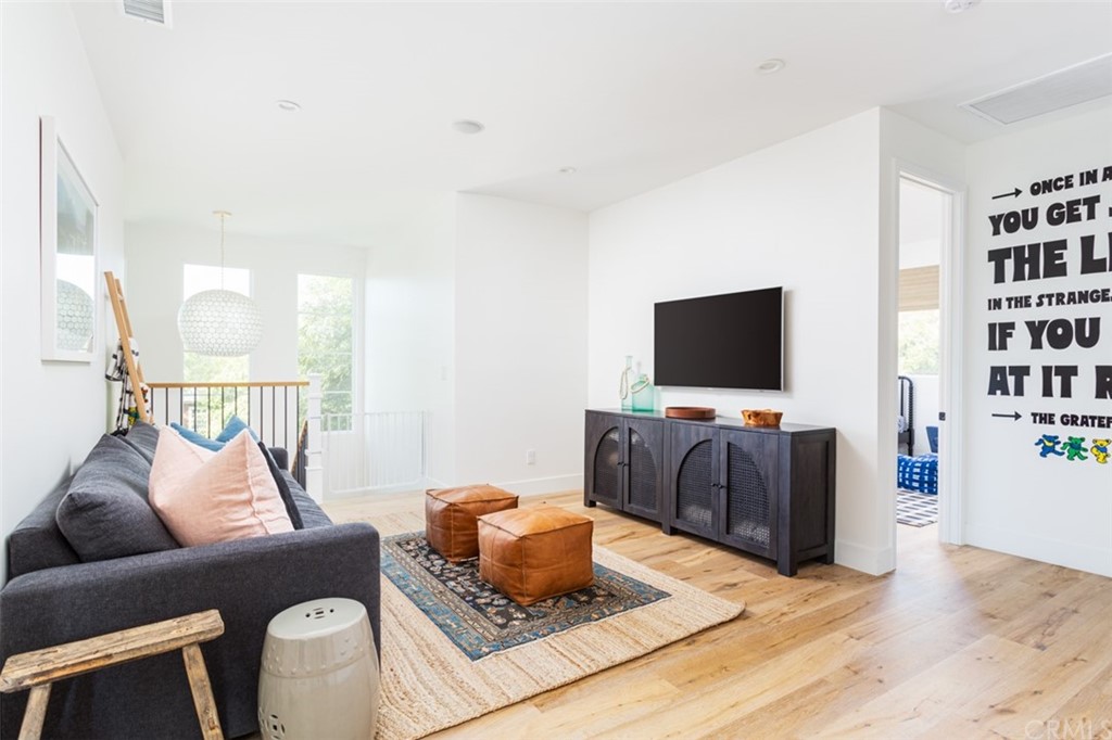 477 Magnolia Street Costa Mesa, CA 92627 - Photo 17 of 29 a living room with furniture and a flat screen tv