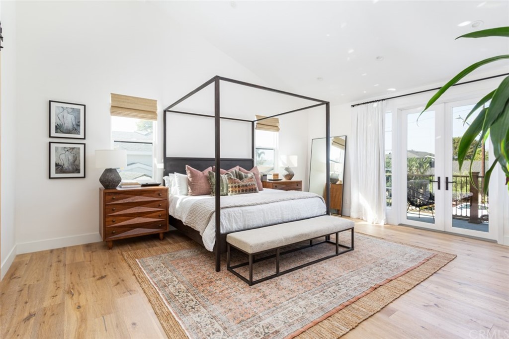 477 Magnolia Street Costa Mesa, CA 92627 - Photo 18 of 29 a bedroom with a bed a mirror and a large window with outer view