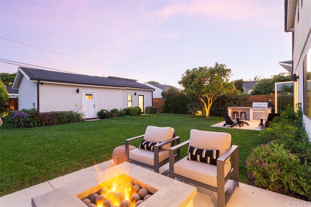 477 Magnolia Street Costa Mesa, CA 92627 - Photo 2 of 29 a view of a house with a backyard and sitting area