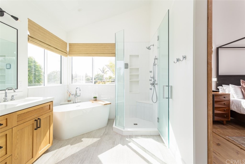 477 Magnolia Street Costa Mesa, CA 92627 - Photo 21 of 29 a bathroom with a double vanity sink toilet next to a window