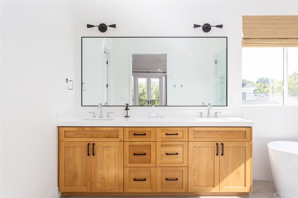 477 Magnolia Street Costa Mesa, CA 92627 - Photo 22 of 29 a bathroom with double sink and a mirror