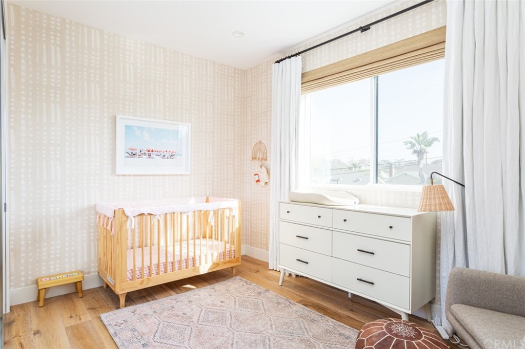 477 Magnolia Street Costa Mesa, CA 92627 - Photo 23 of 29 a room with a baby crib and a dresser