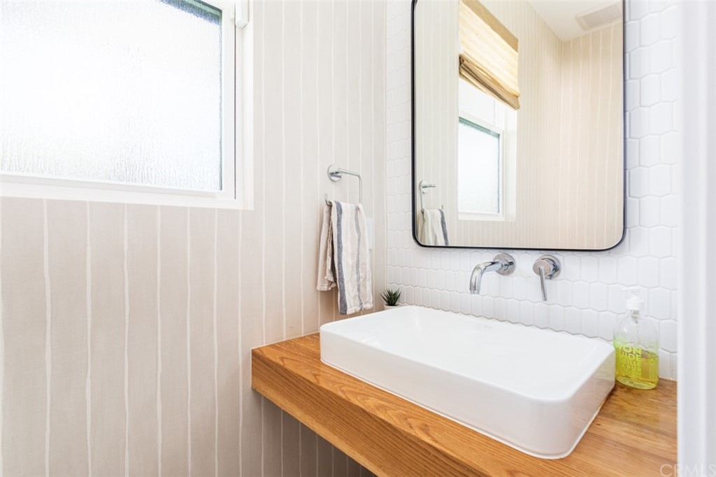 477 Magnolia Street Costa Mesa, CA 92627 - Photo 24 of 29 a bathroom with a sink and a mirror