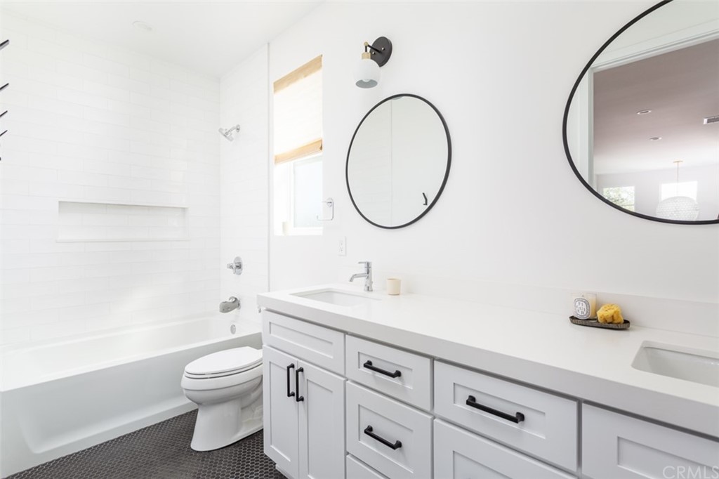 477 Magnolia Street Costa Mesa, CA 92627 - Photo 26 of 29 a bathroom with a toilet a sink and a mirror