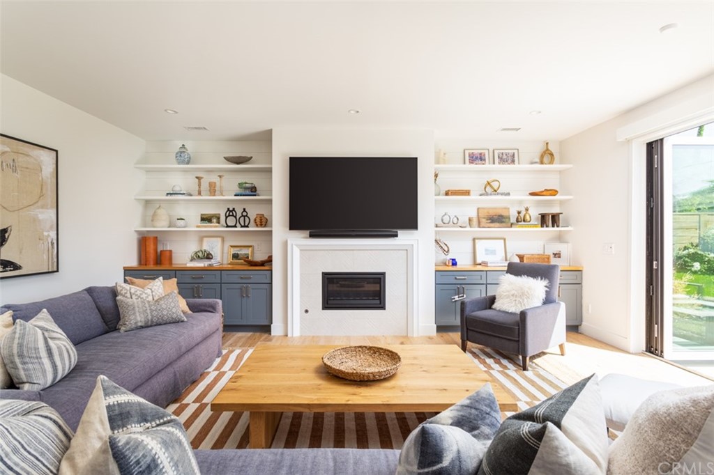 477 Magnolia Street Costa Mesa, CA 92627 - Photo 6 of 29 a living room with furniture a flat screen tv and a fireplace