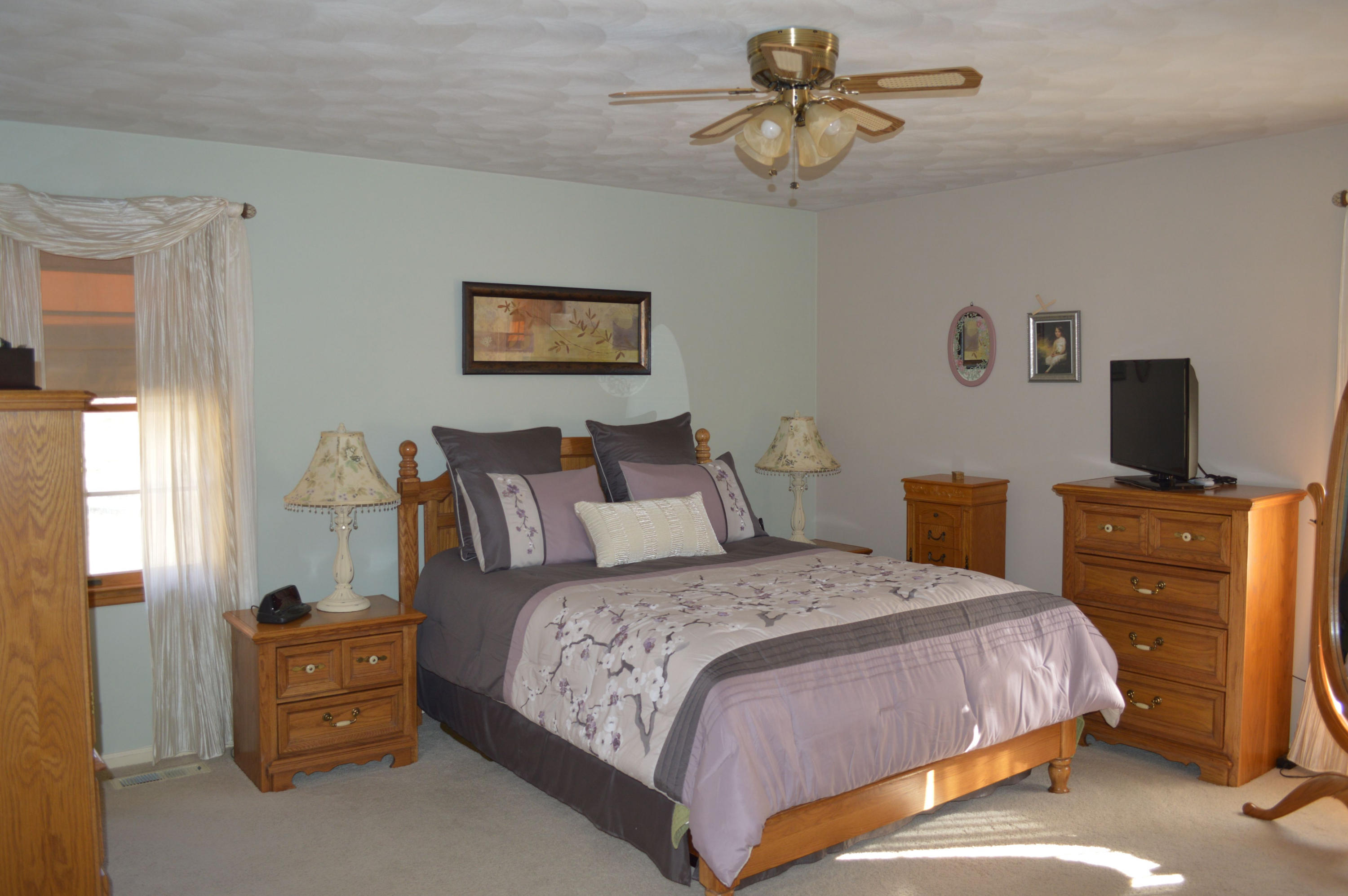 92 Oak Crest Drive Blue Ridge, VA 24064 - Photo 4 of 48 a bedroom with a bed and a chandelier