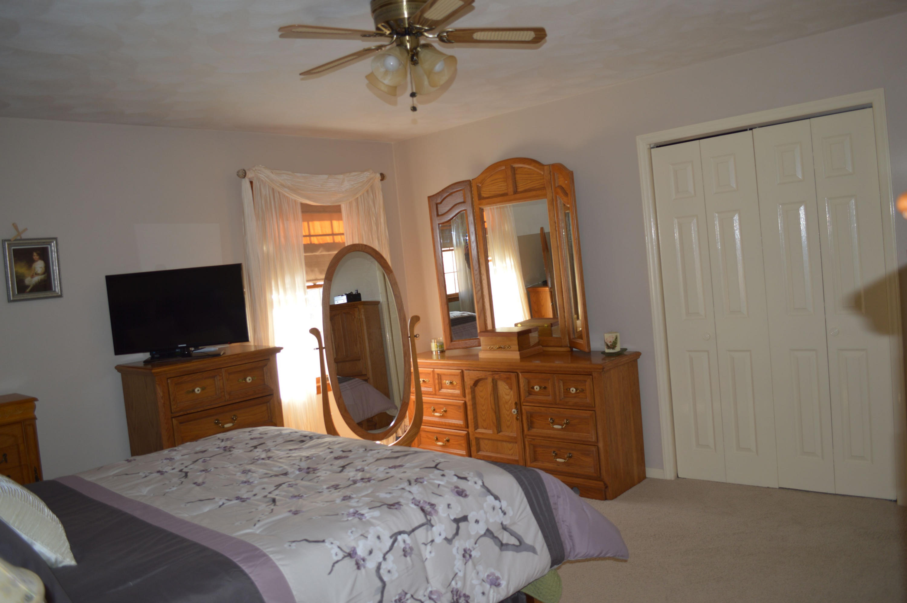 92 Oak Crest Drive Blue Ridge, VA 24064 - Photo 5 of 48 a bedroom with a bed a dresser and flat screen tv