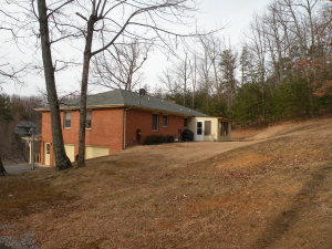 92 Oak Crest Drive Blue Ridge, VA 24064 - Photo 43 of 48 a front view of a house with a yard and garage