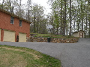92 Oak Crest Drive Blue Ridge, VA 24064 - Photo 48 of 48 a backyard of a house with large trees and outdoor seating