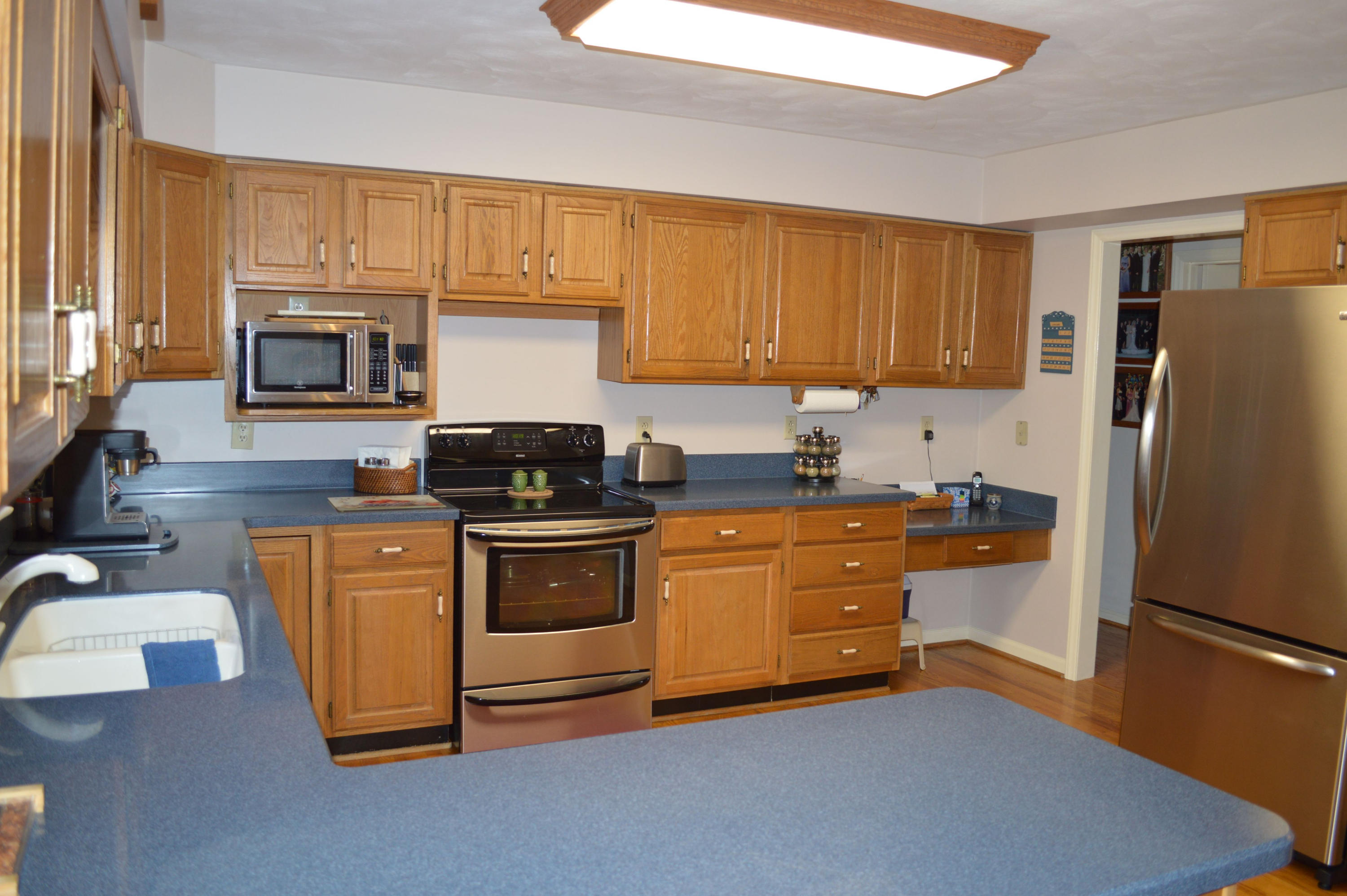 92 Oak Crest Drive Blue Ridge, VA 24064 - Photo 10 of 48 a kitchen with granite countertop a refrigerator stove top oven and sink