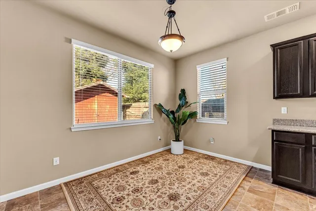 a view of a livingroom with a window and wooden floor