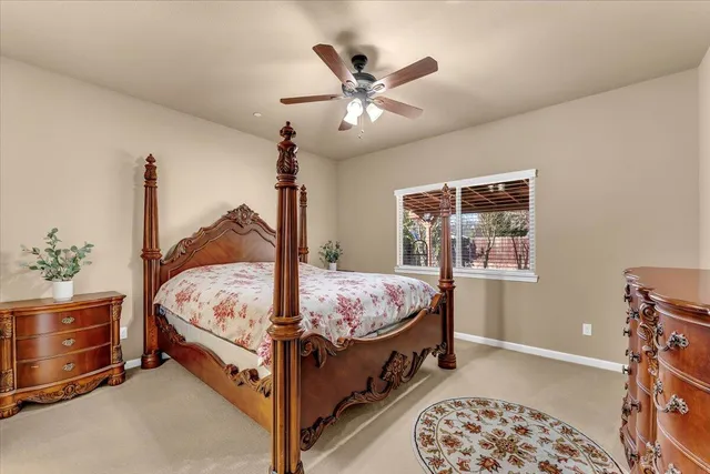 a bed sitting in a bedroom next to a window