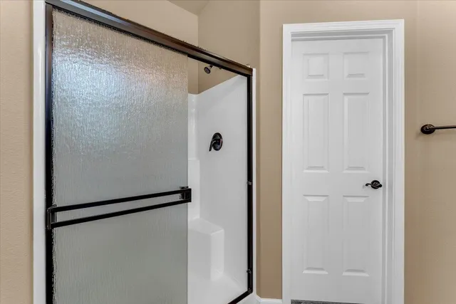 a bathroom with a glass shower door