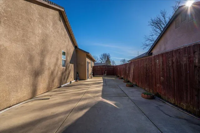 a view of a house with wooden fence