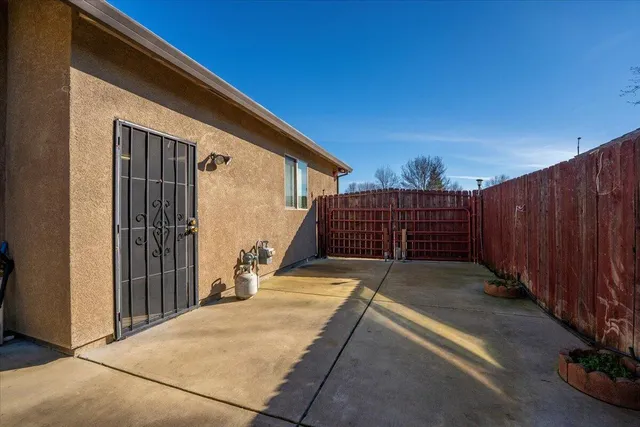 a view of backyard with wooden fence
