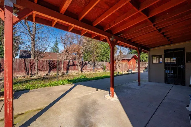 a view of a backyard with wooden fence