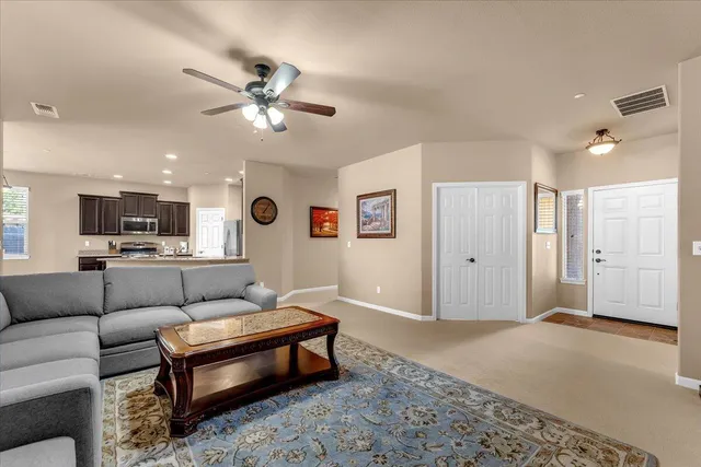a living room with furniture and kitchen view