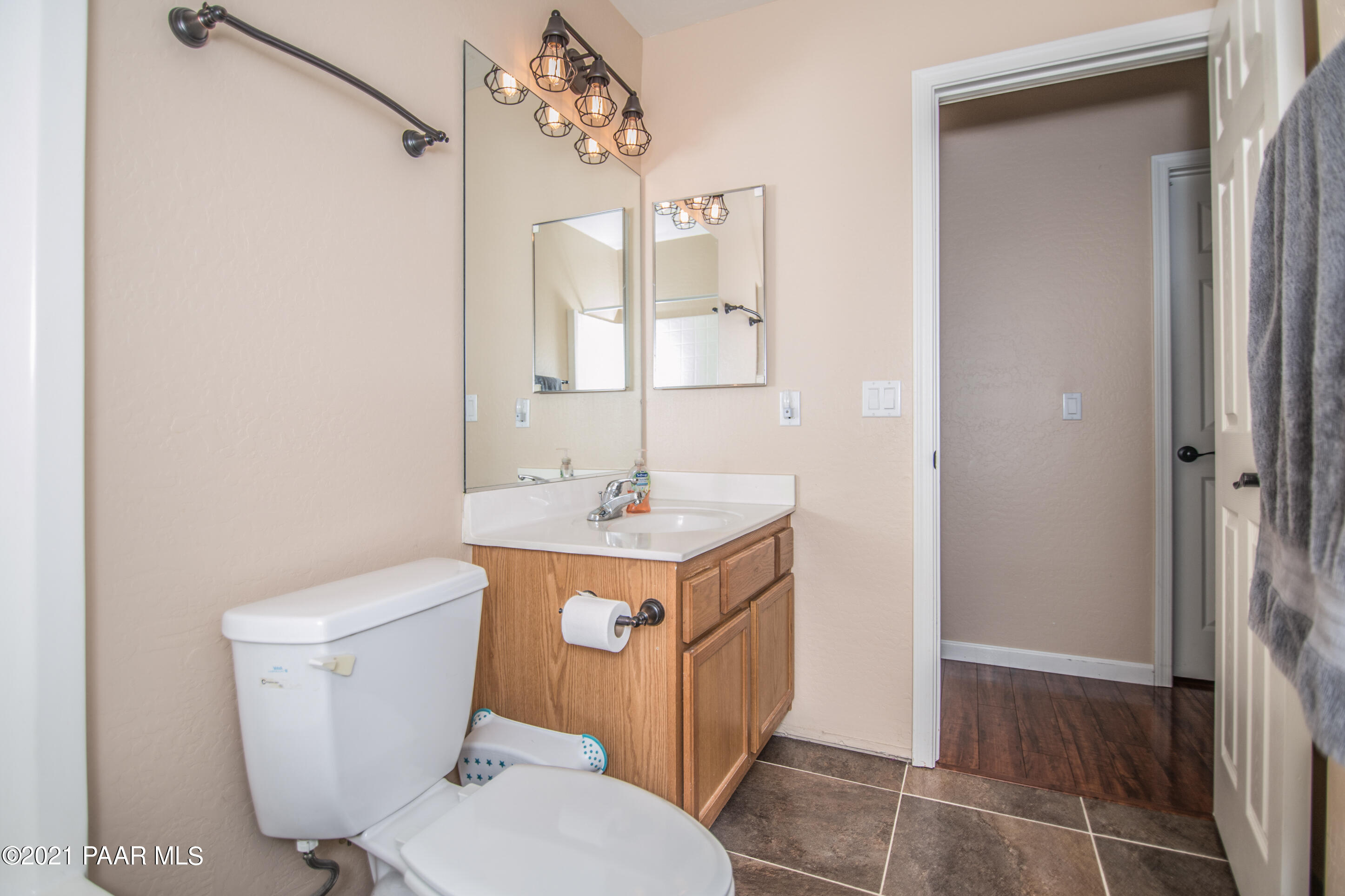 7402 East Plateau Ridge Road Prescott Valley, AZ 86315 - Photo 18 of 31 a bathroom with a toilet sink and mirror