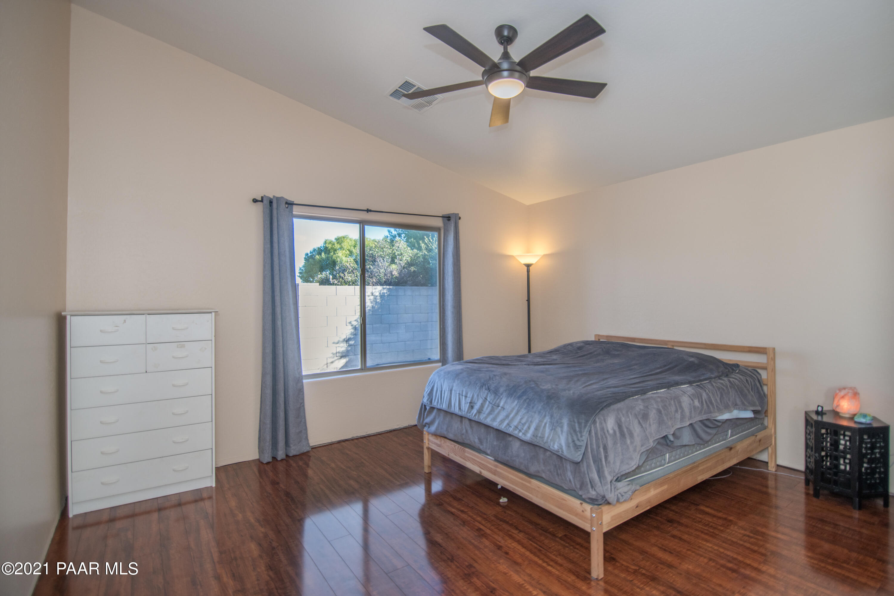 7402 East Plateau Ridge Road Prescott Valley, AZ 86315 - Photo 21 of 31 a bedroom with a bed and a chandelier