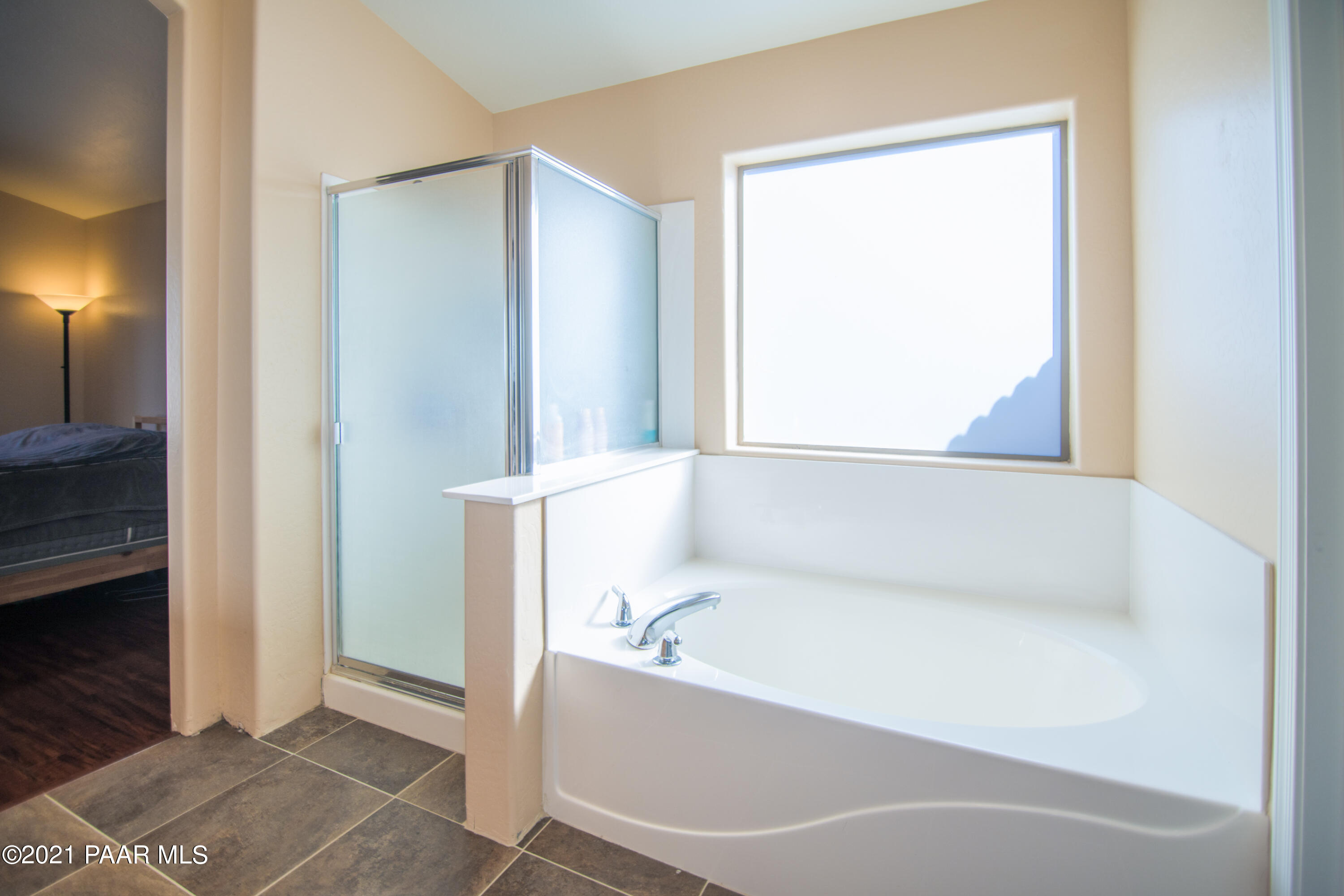 7402 East Plateau Ridge Road Prescott Valley, AZ 86315 - Photo 24 of 31 a bathroom with a bathtub and a shower