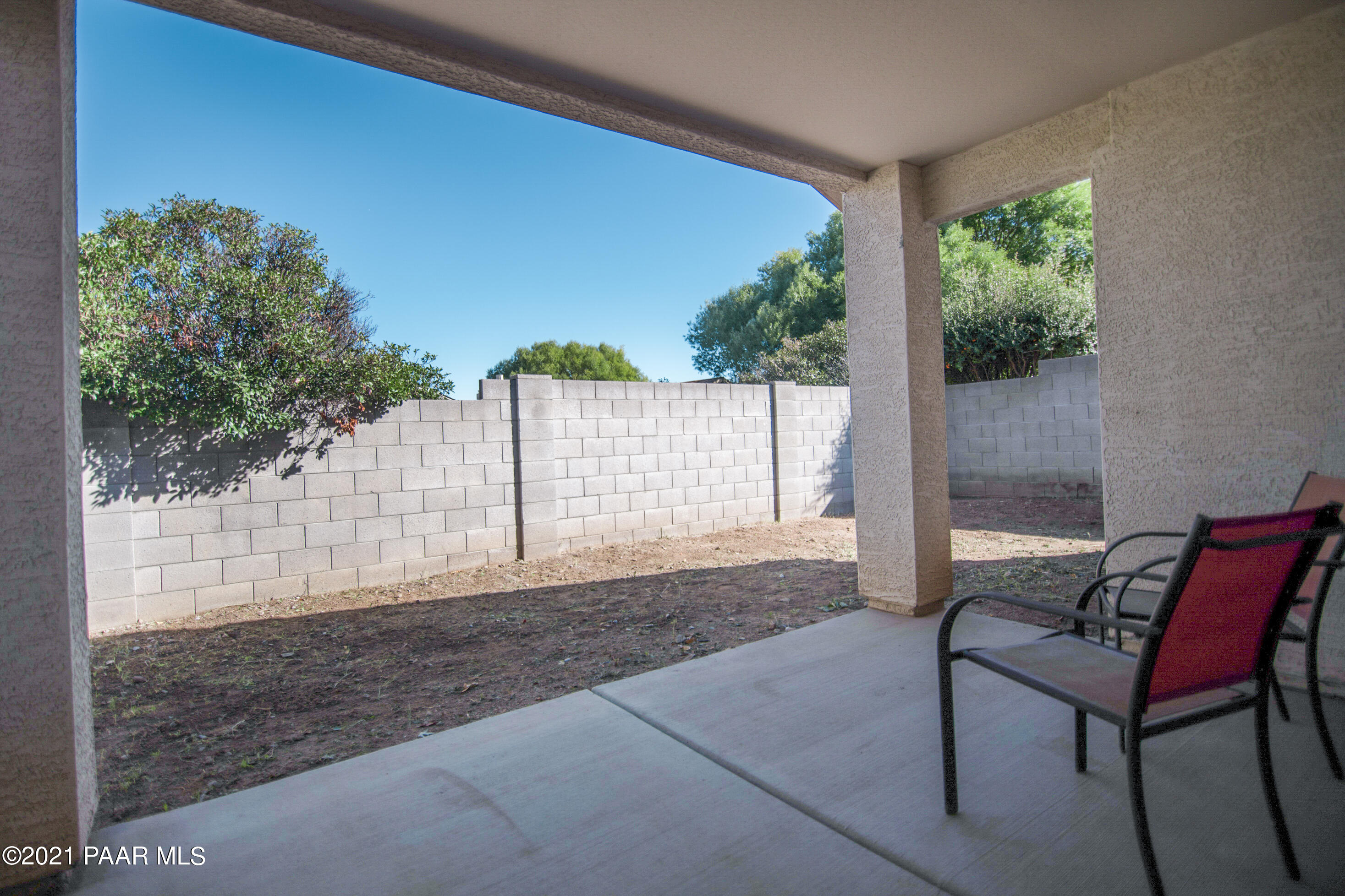 7402 East Plateau Ridge Road Prescott Valley, AZ 86315 - Photo 28 of 31 a view of a porch with furniture and a yard