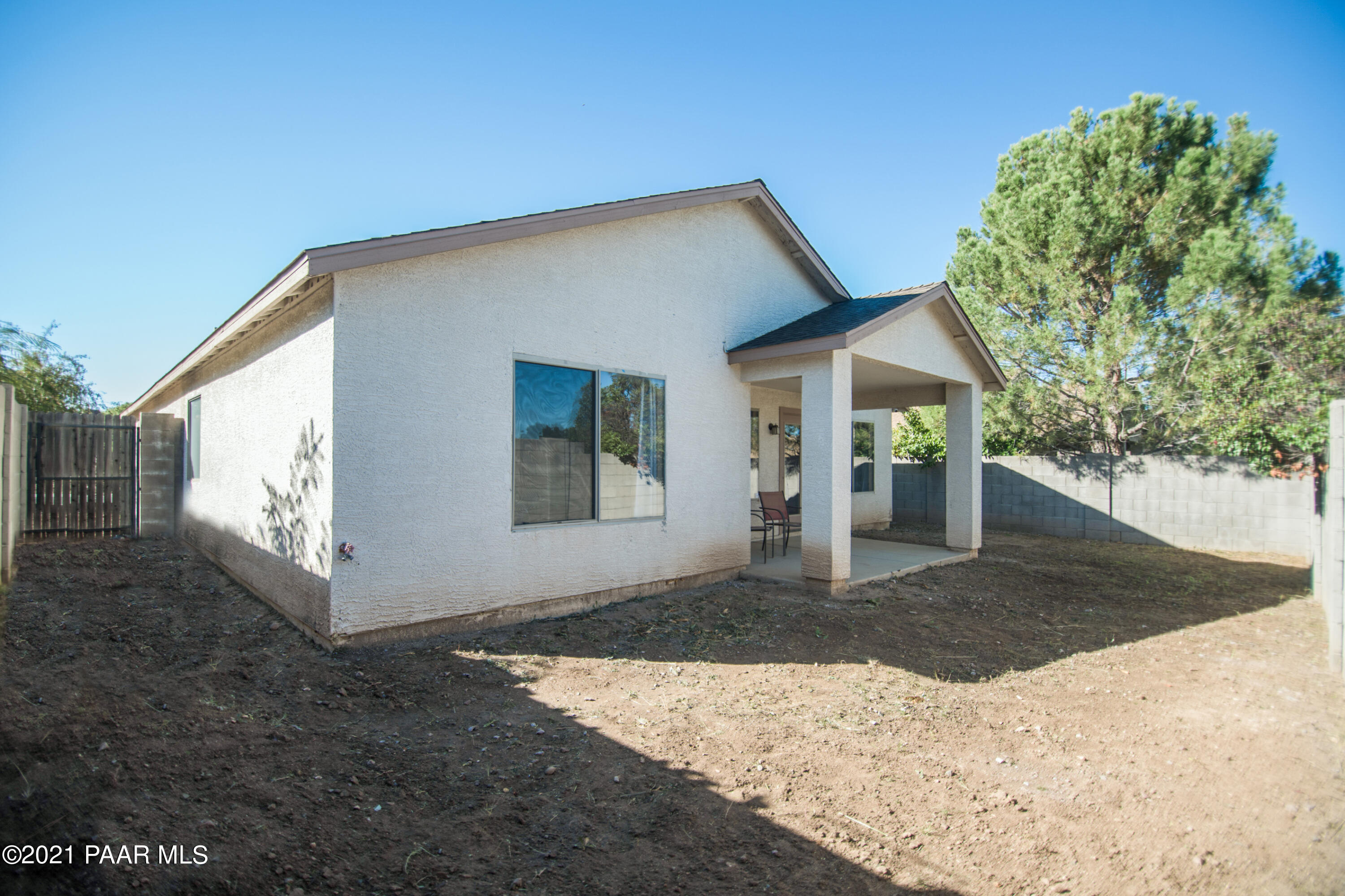 7402 East Plateau Ridge Road Prescott Valley, AZ 86315 - Photo 29 of 31 a view of a house with a yard and potted plants