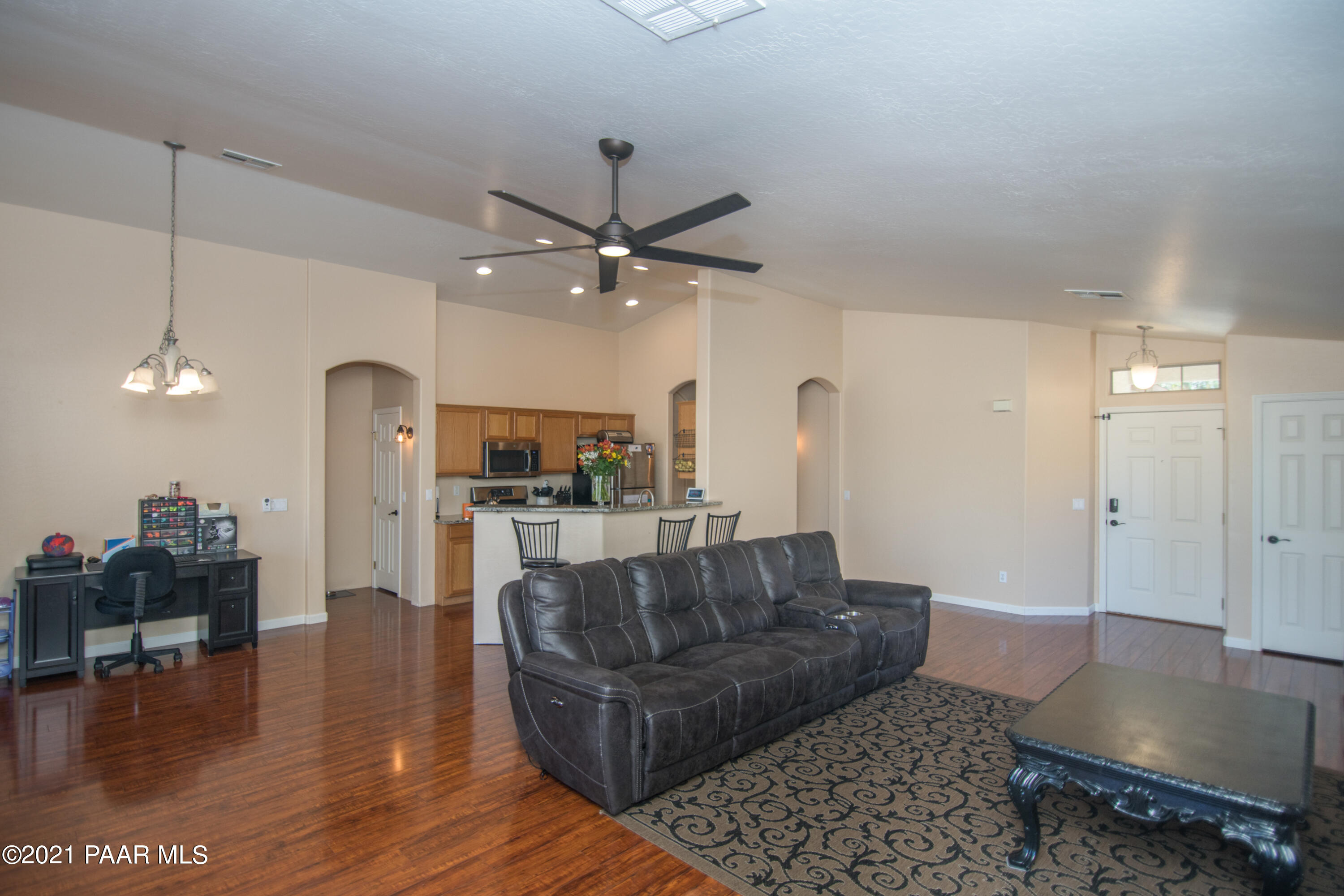 7402 East Plateau Ridge Road Prescott Valley, AZ 86315 - Photo 5 of 31 a living room with furniture and a chandelier