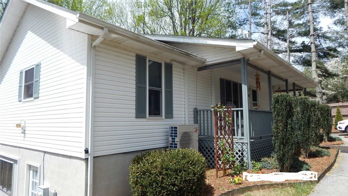 190 Kings Road Boone, NC 28607 - Photo 2 of 15 a view of a white house with a potted plant and a large tree