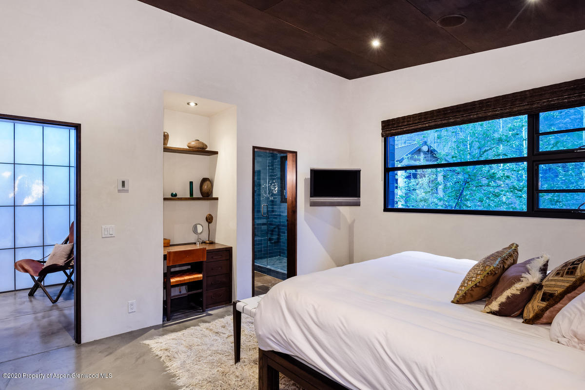 263 Park Avenue Aspen, CO 81611 - Photo 19 of 32 a bedroom with a large bed and a tv