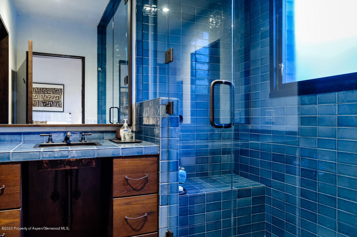 263 Park Avenue Aspen, CO 81611 - Photo 20 of 32 a bathroom with a granite countertop sink a toilet and mirror