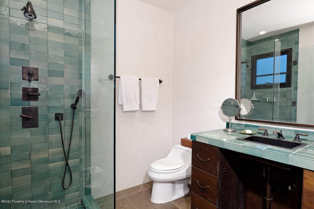 263 Park Avenue Aspen, CO 81611 - Photo 27 of 32 a bathroom with a granite countertop sink toilet and shower