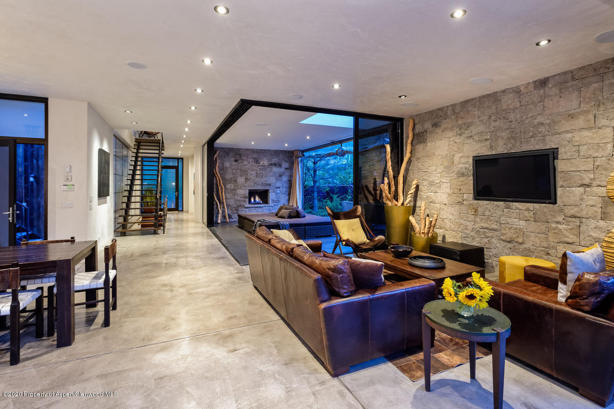 263 Park Avenue Aspen, CO 81611 - Photo 3 of 32 a living room with furniture a flat screen tv and kitchen view