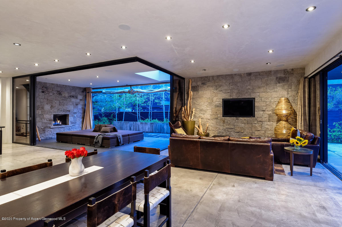 263 Park Avenue Aspen, CO 81611 - Photo 4 of 32 a living room with furniture flat screen tv and a large window