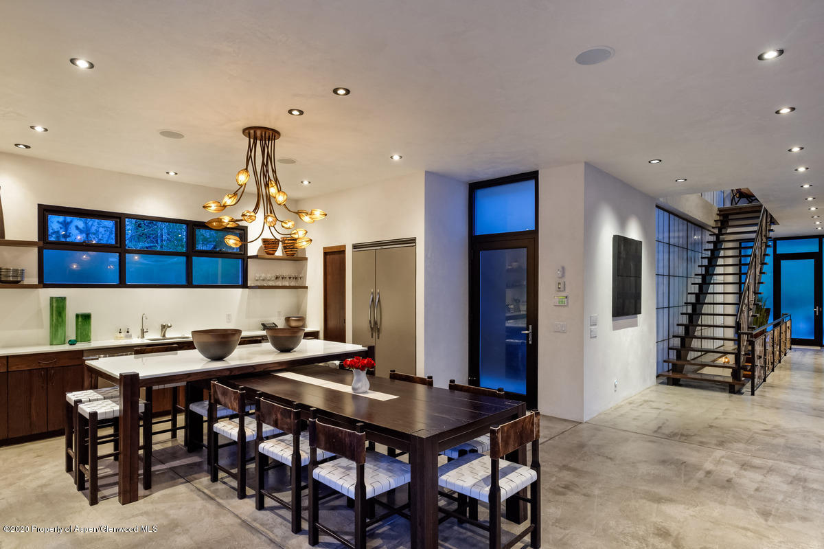 263 Park Avenue Aspen, CO 81611 - Photo 5 of 32 a kitchen with a table chairs and a refrigerator