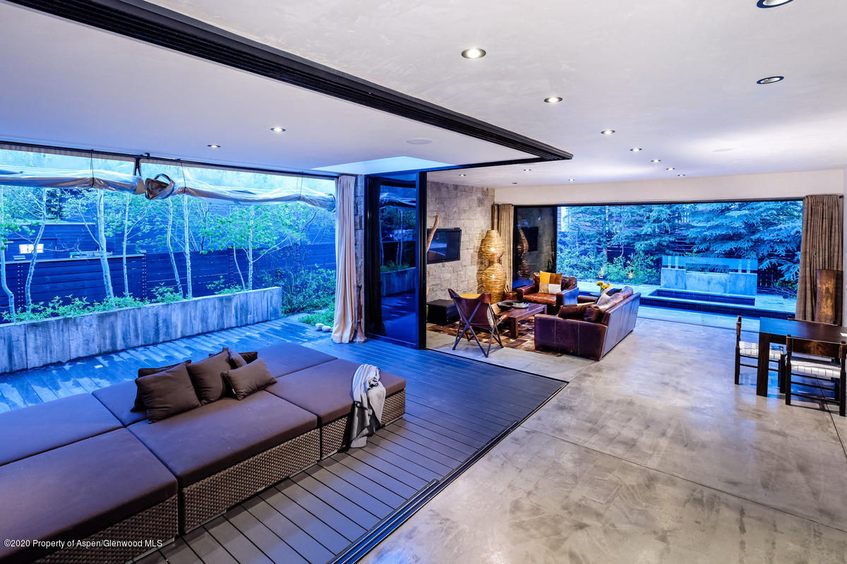 263 Park Avenue Aspen, CO 81611 - Photo 9 of 32 a living room with furniture a table and kitchen view