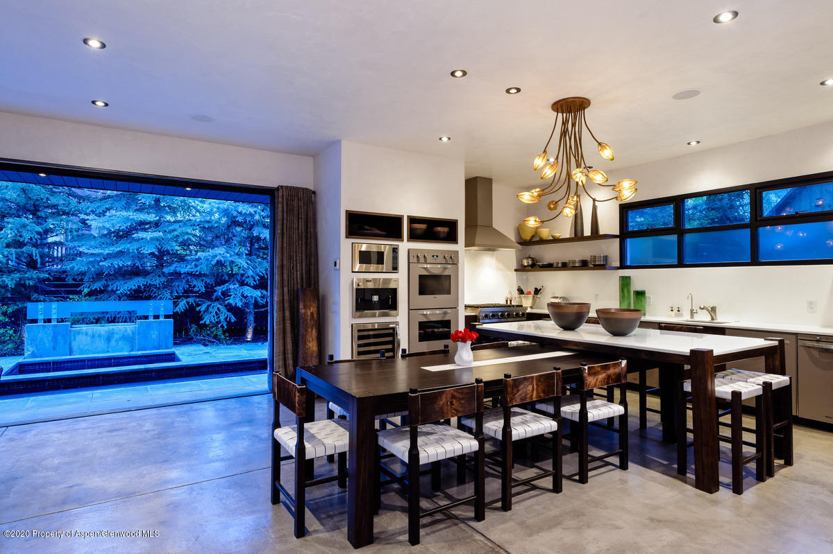 263 Park Avenue Aspen, CO 81611 - Photo 10 of 32 a kitchen with stainless steel appliances a dining table and chairs