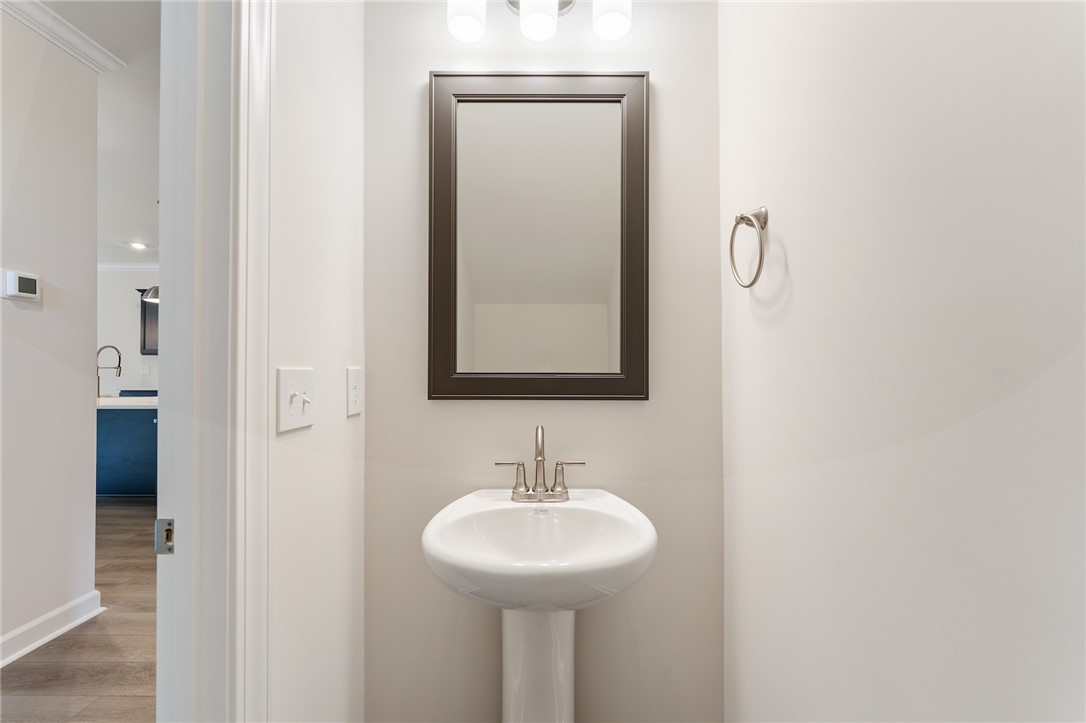 1108 Manse Jolly Road Anderson, SC 29621 - Photo 19 of 45 This clean and bright powder room features a classic pedestal sink, perfect for everyday convenience.