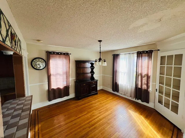 a view of a kitchen with refrigerator and windows