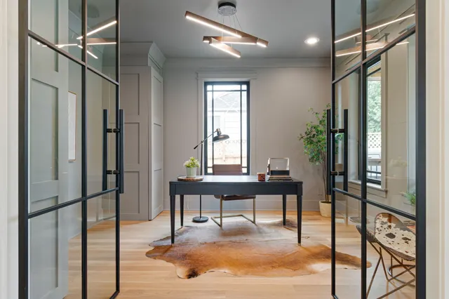 a dining room with furniture a chandelier and wooden floor