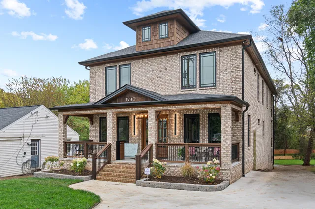 a front view of a house with a yard table and chairs