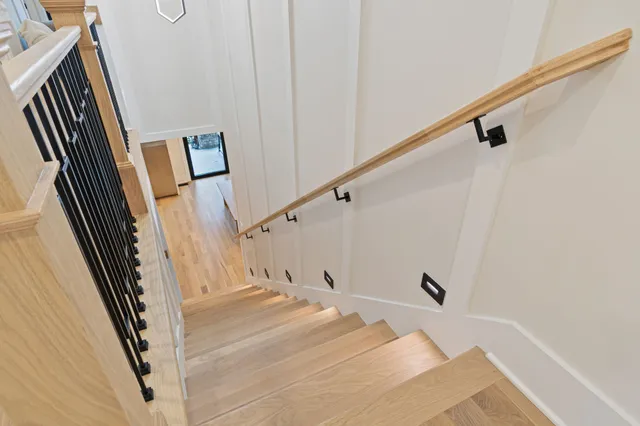 a living room with furniture a chandelier and a dining room