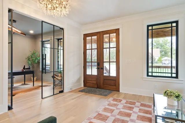 a living room with furniture and a chandelier