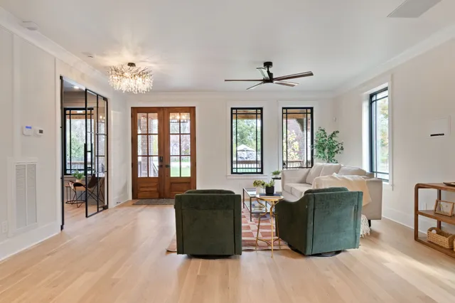 a large kitchen with kitchen island a large counter top space a sink stainless steel appliances and cabinets