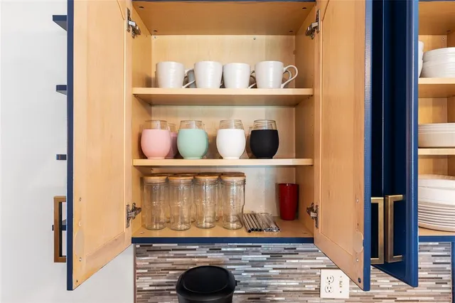 a kitchen with a potted plant and a cabinet