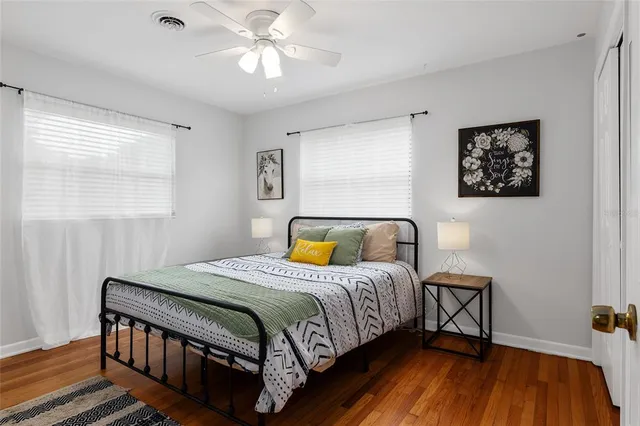 a bedroom with furniture and a wooden floor