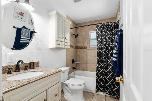a living room with furniture a window and a chandelier