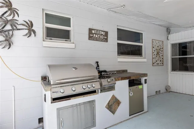 an aerial view of a house with a yard basket ball court and outdoor seating